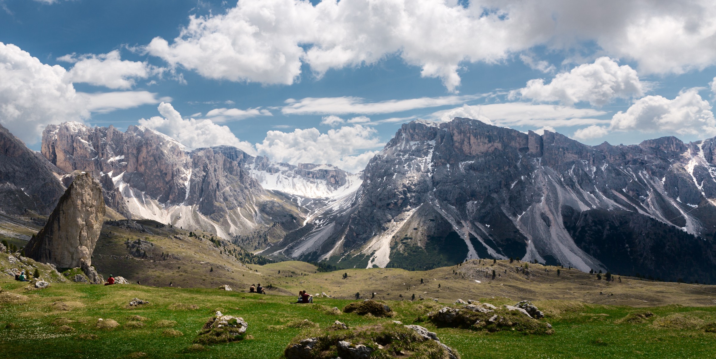 Jagged Dolomite peaks rising above a green alpine meadow