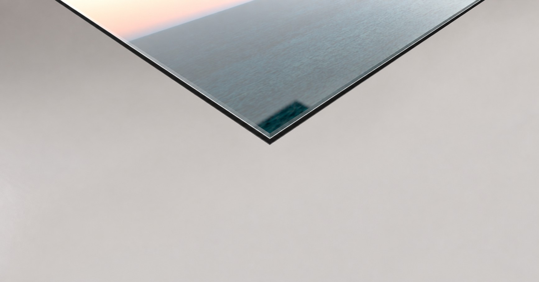 Detail of a photograph mounted beneath acrylic glass, showing the material's polished edge and thickness